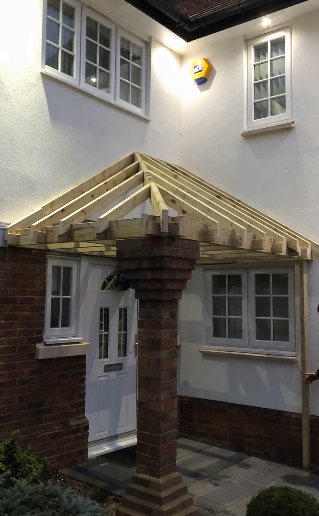 New timber roof frame for a porch on a brick house