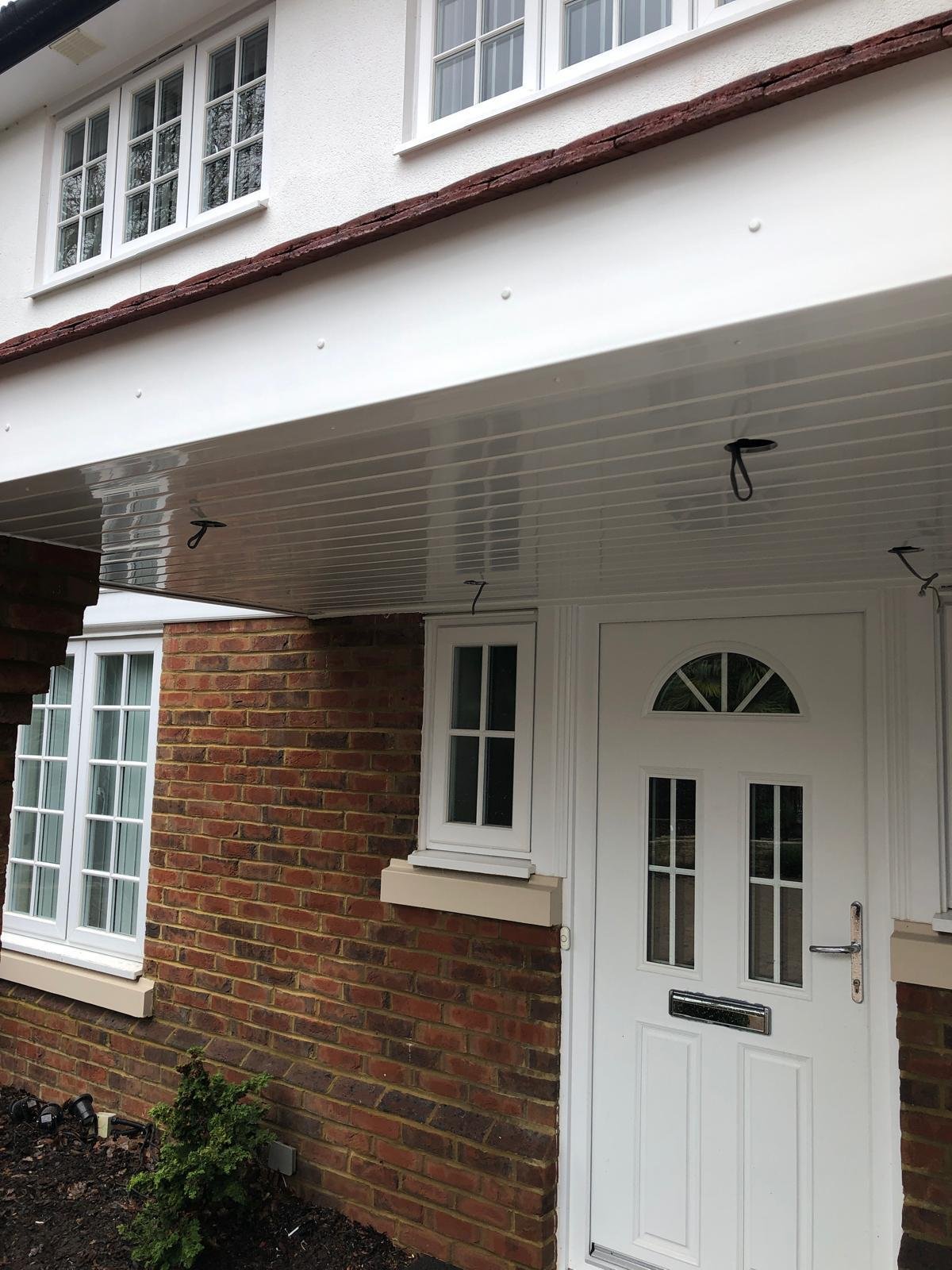 White uPVC soffit and fascia on a porch canopy above a front door